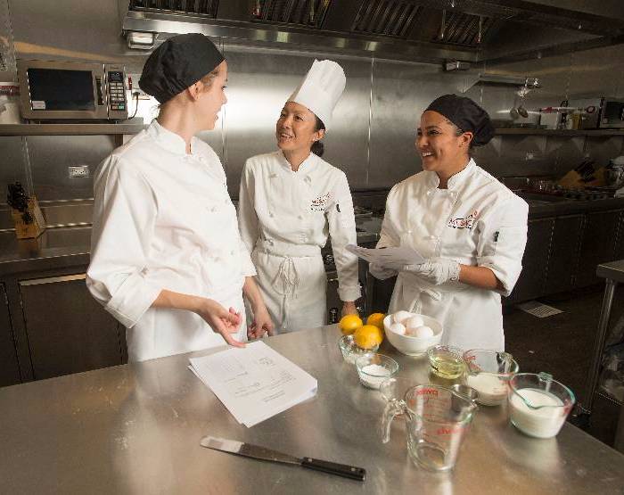Professor Mee Shum works with culinary students. Some certificate programs only take one semester to complete