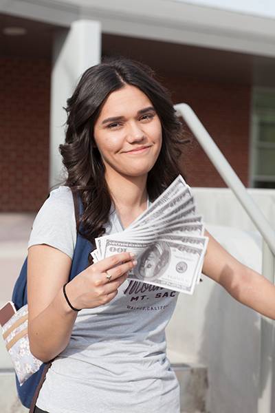 Girl holding hundred-dollar bills