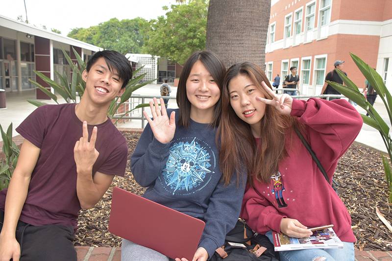 students waving to the camera