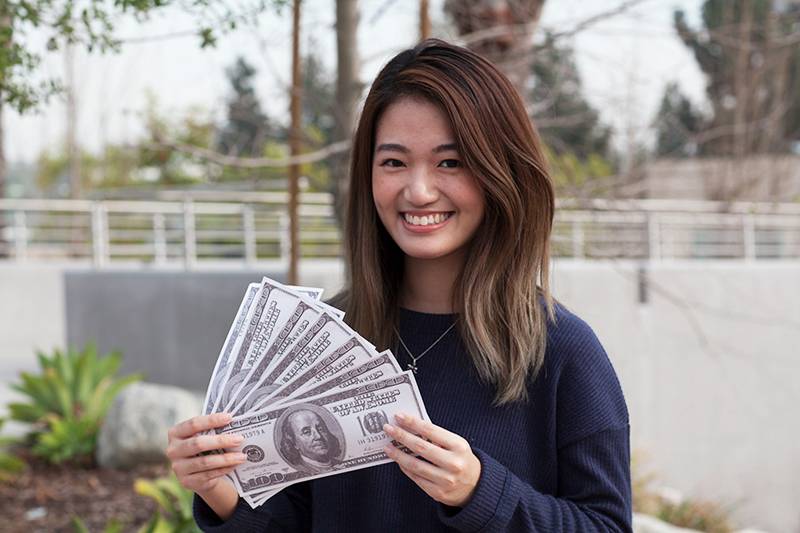Picture of a student holding cash