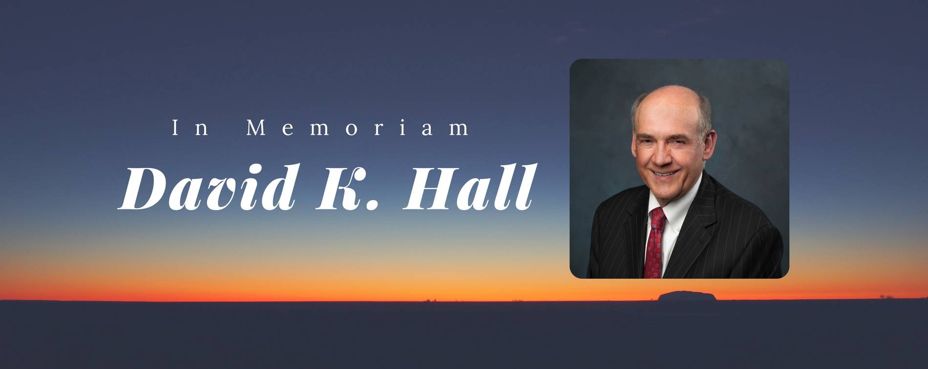 A sunset with an image of Trustee David Hall