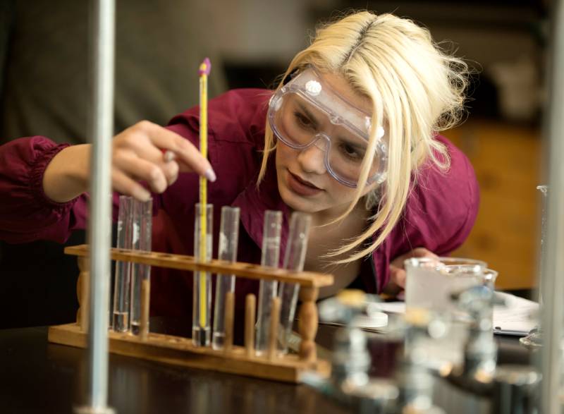 A student examines a liquid in a chemistry lab at Mt. SAC.