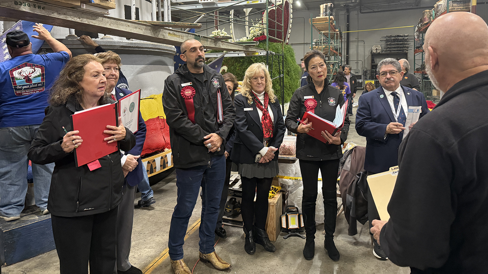 Chaz Perea stands among his fellow Rose Parade judges, listening to instructions.