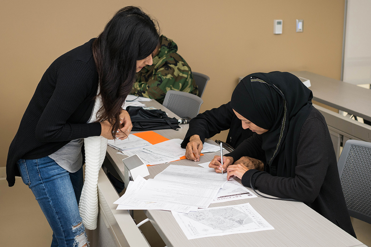 A VITA volunteer worker helps members of the community with their taxes.