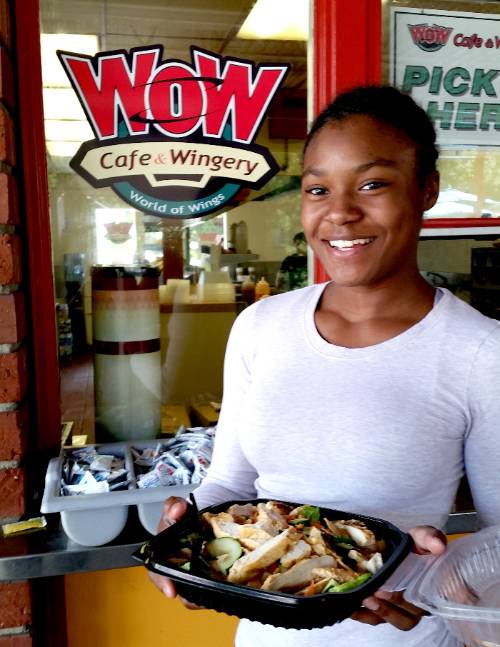A student holds a salad from WOW cafe. A student holds a salad from WOW cafe.