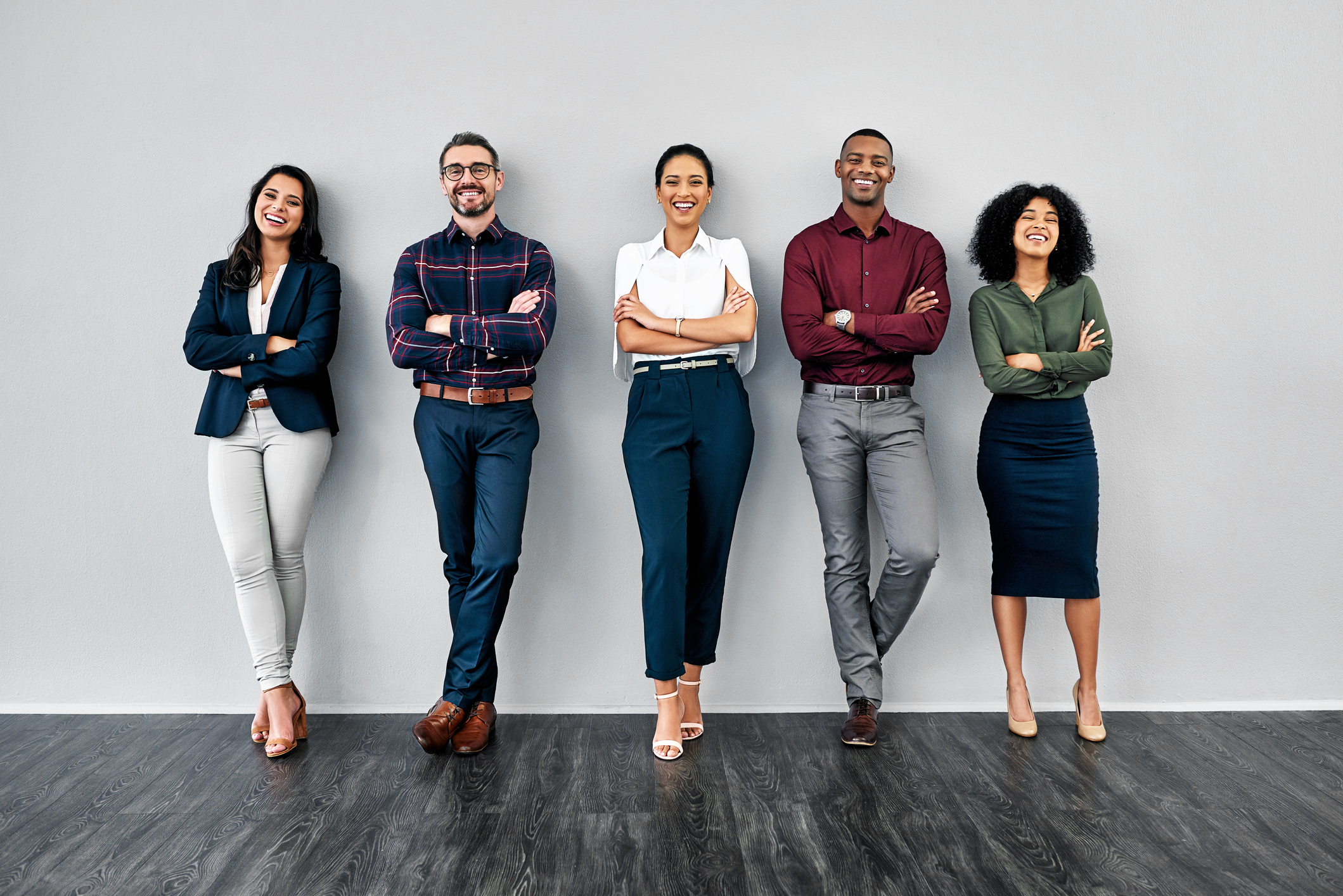 Business professionals standing against wall