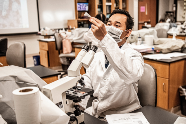 masked student in lab