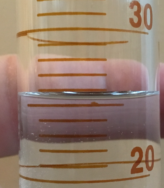 Close up of 50 mL graduated cylinder for reading