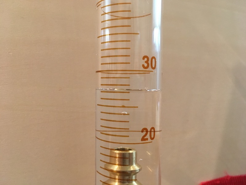 Volume reading on graduated cylinder with object for measurement