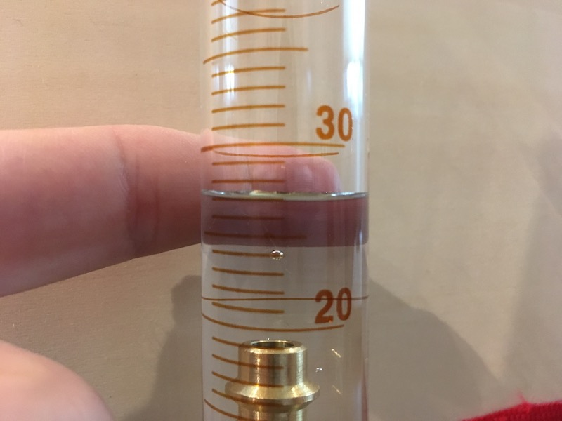 Volume reading on graduated cylinder with object and contrast for measurement