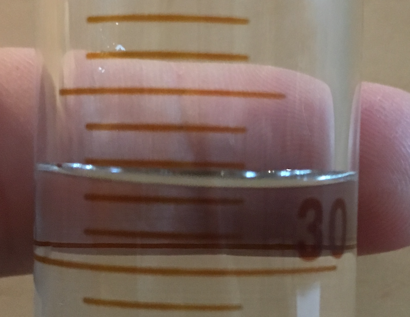 Close up of 50 mL graduated cylinder for reading