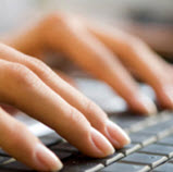 Person typing on keyboard