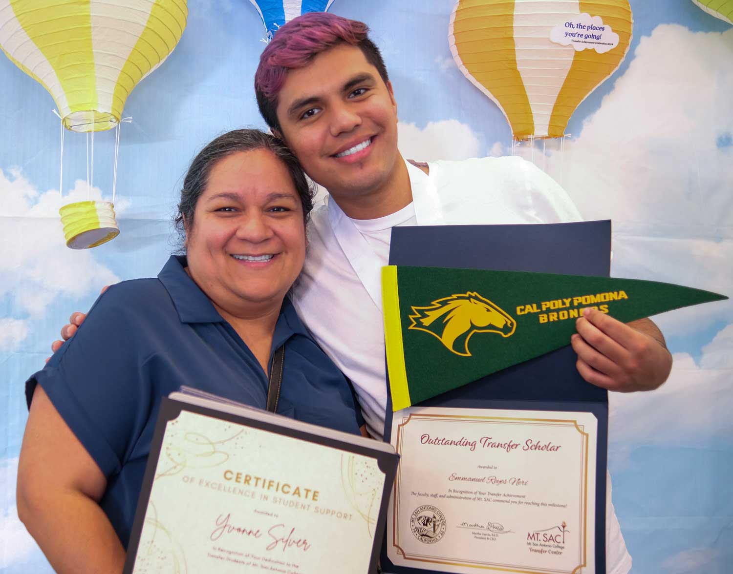  Transfer students celebrating with certificates and Cal Poly Pomona pennant