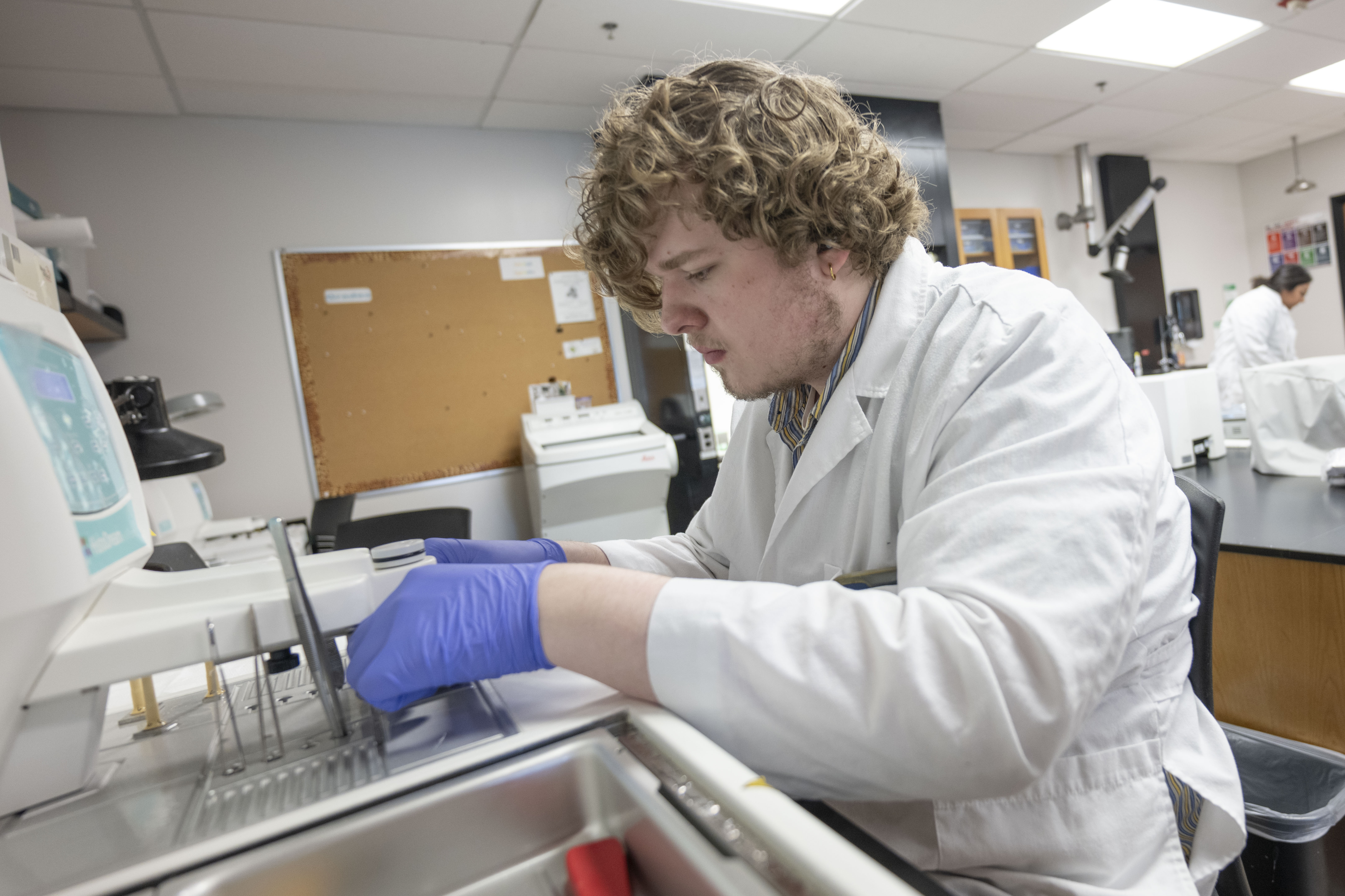 Science student dressed in white coat