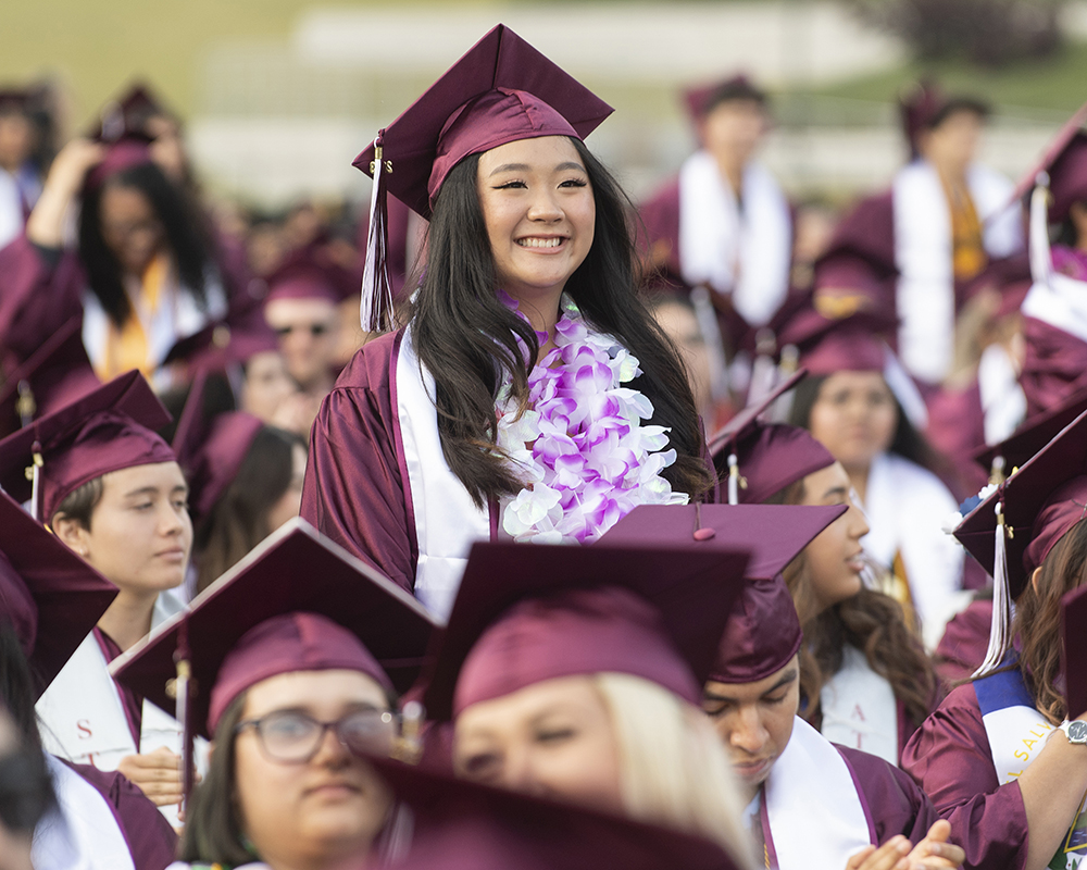 Mt. SAC graduate stands in the crowd at commencement.