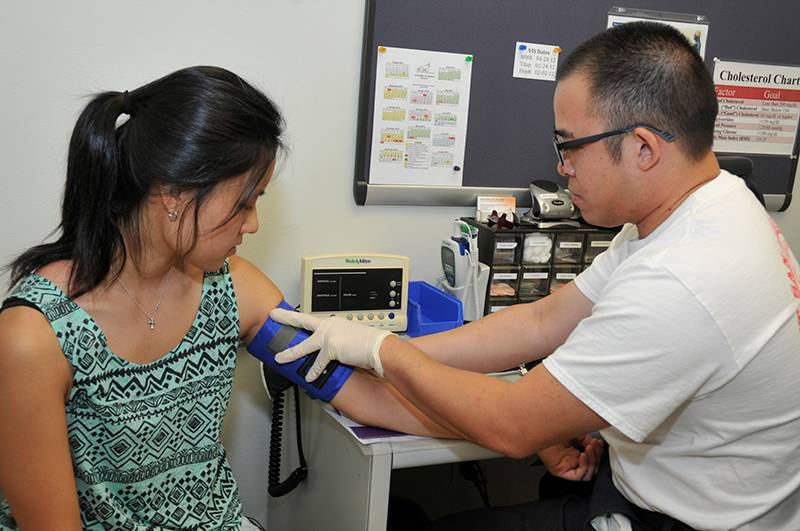 student having her blood pressure taken