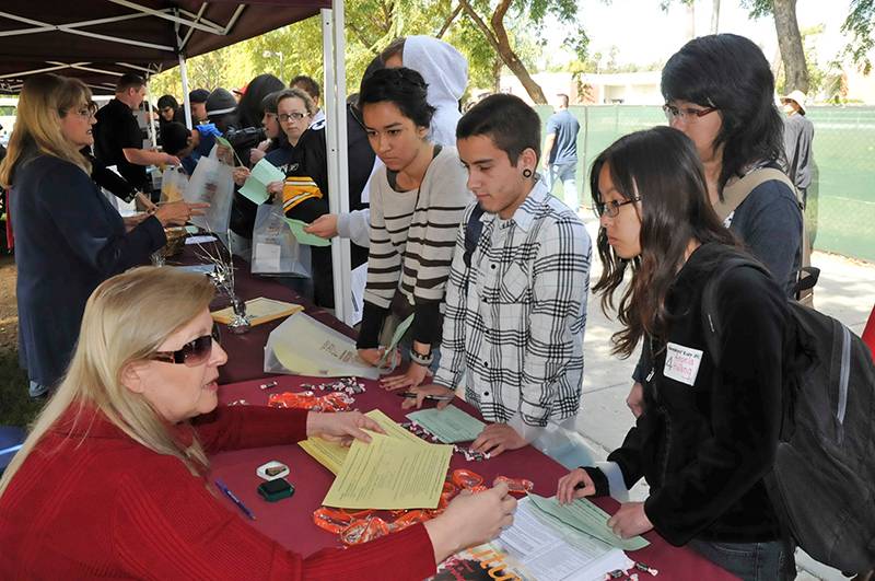 several students being helped by staff at juniors day