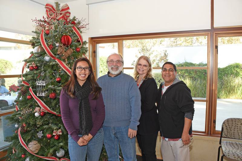 Mt. SAC employees in front of a Christmas tree