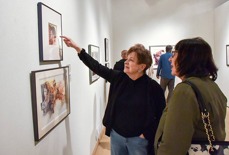 a photo of people taking in an art gallery exhibit