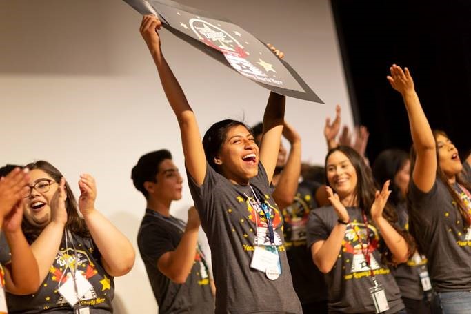 Students on stage cheering