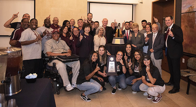 Athletics Department with Board and Womens Softball team