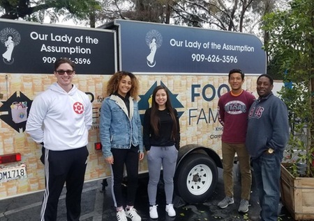 Student athletes standing in front of truck