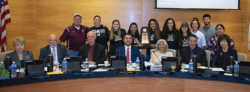 Women's Softball team with the Board