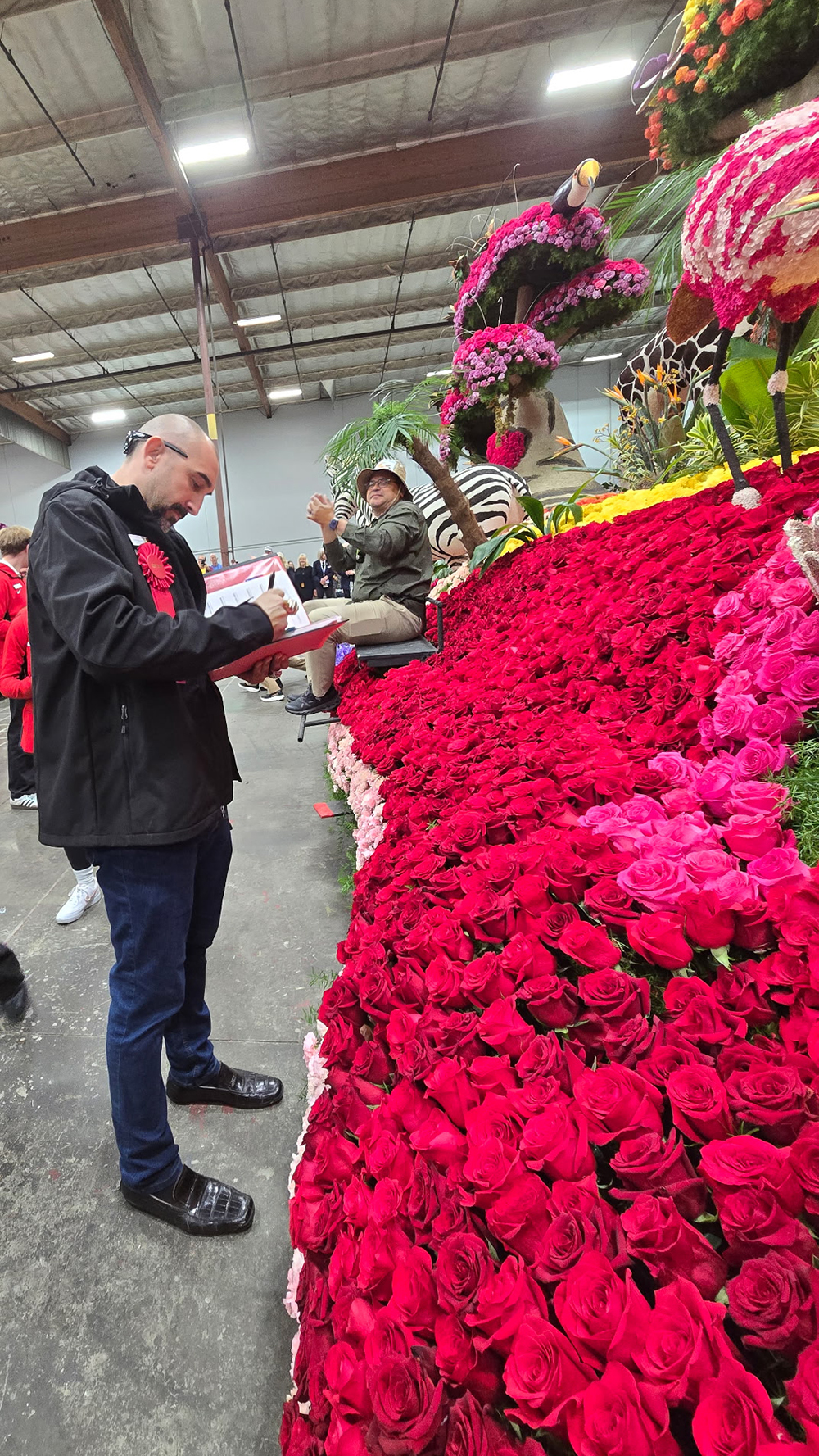 Chaz Perea makes notes on a float he is judging. 
