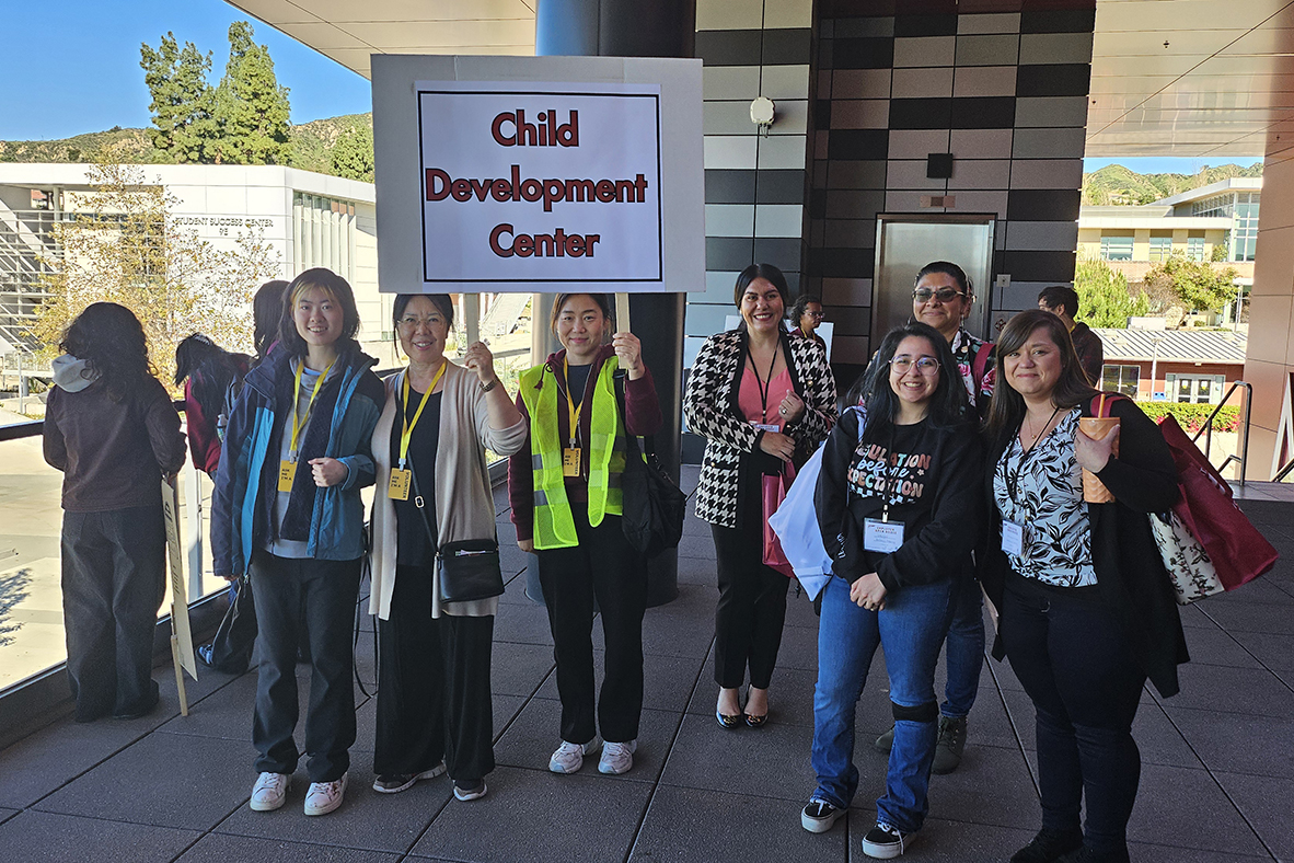 Students hold up their tour guide signs to gather their group together.