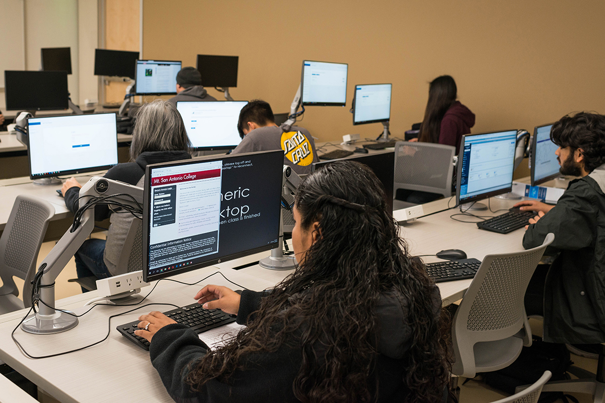 Members of the campus community work on their tax returns in a computer lab.