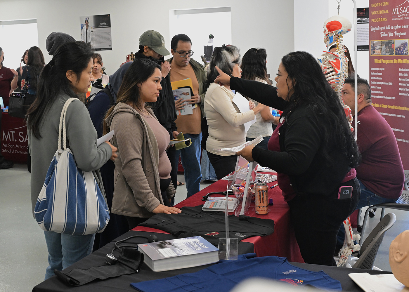 Members of the community gather information at a booth at the School of Continuing Education Open House.