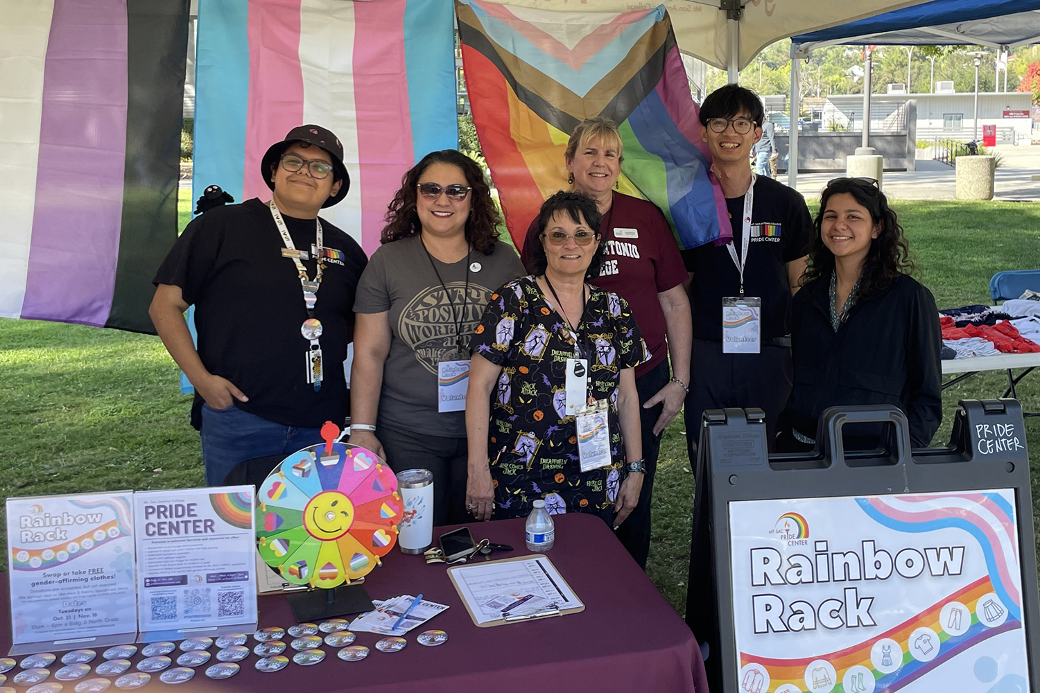 Mt. SAC's Pride Center staff and students take a group photo at their booth at the Rainbow Rack event.