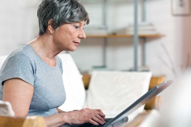 adult student works on laptop