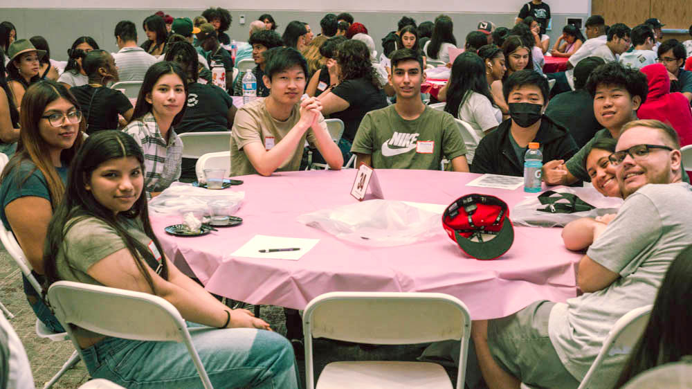 Students  smile at table