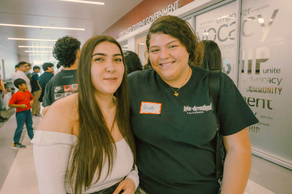 Two students smile for camera