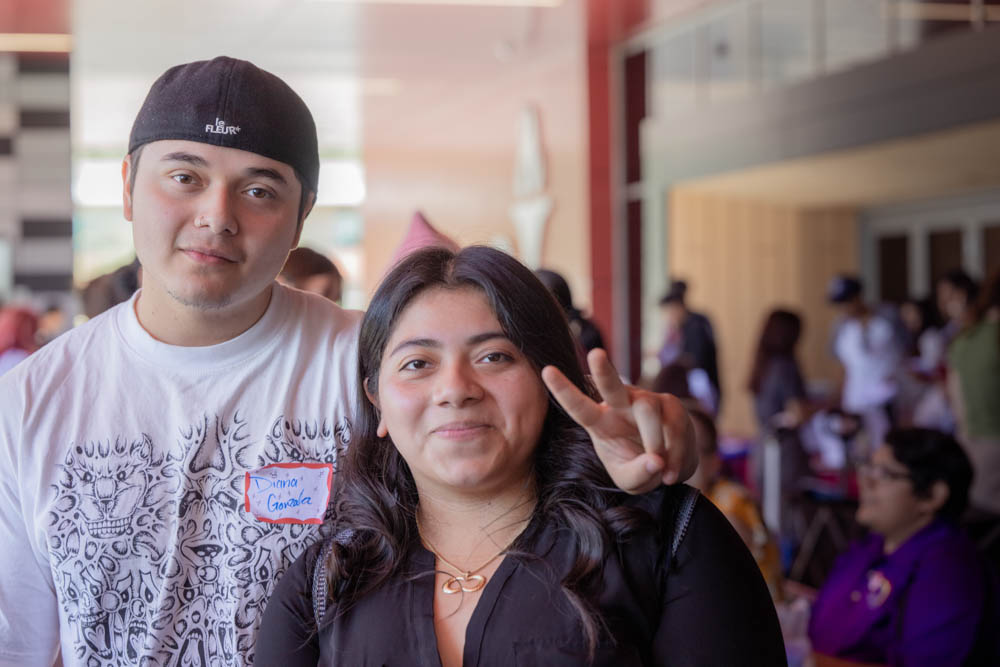 Two students smile