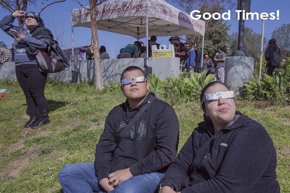 "Good Times!" - couple look up at eclipse with glasses