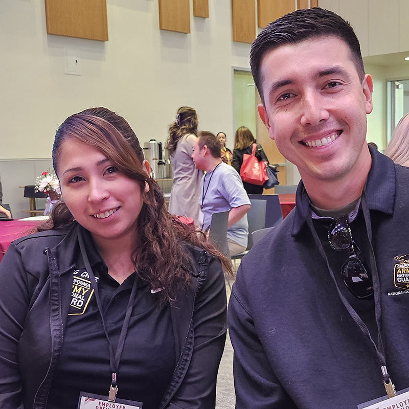 A pair of job recruiters attend a career conference.