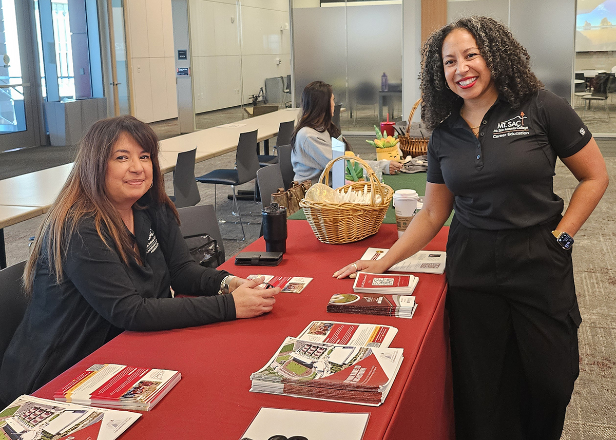 Mt. SAC staff pose for a photo at their career information booth. 