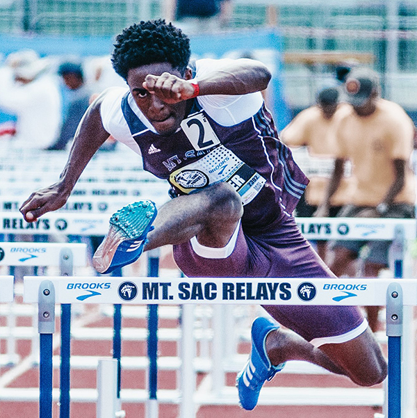 A hurdler leaps over an obstacle at the Mt. SAC Relays.