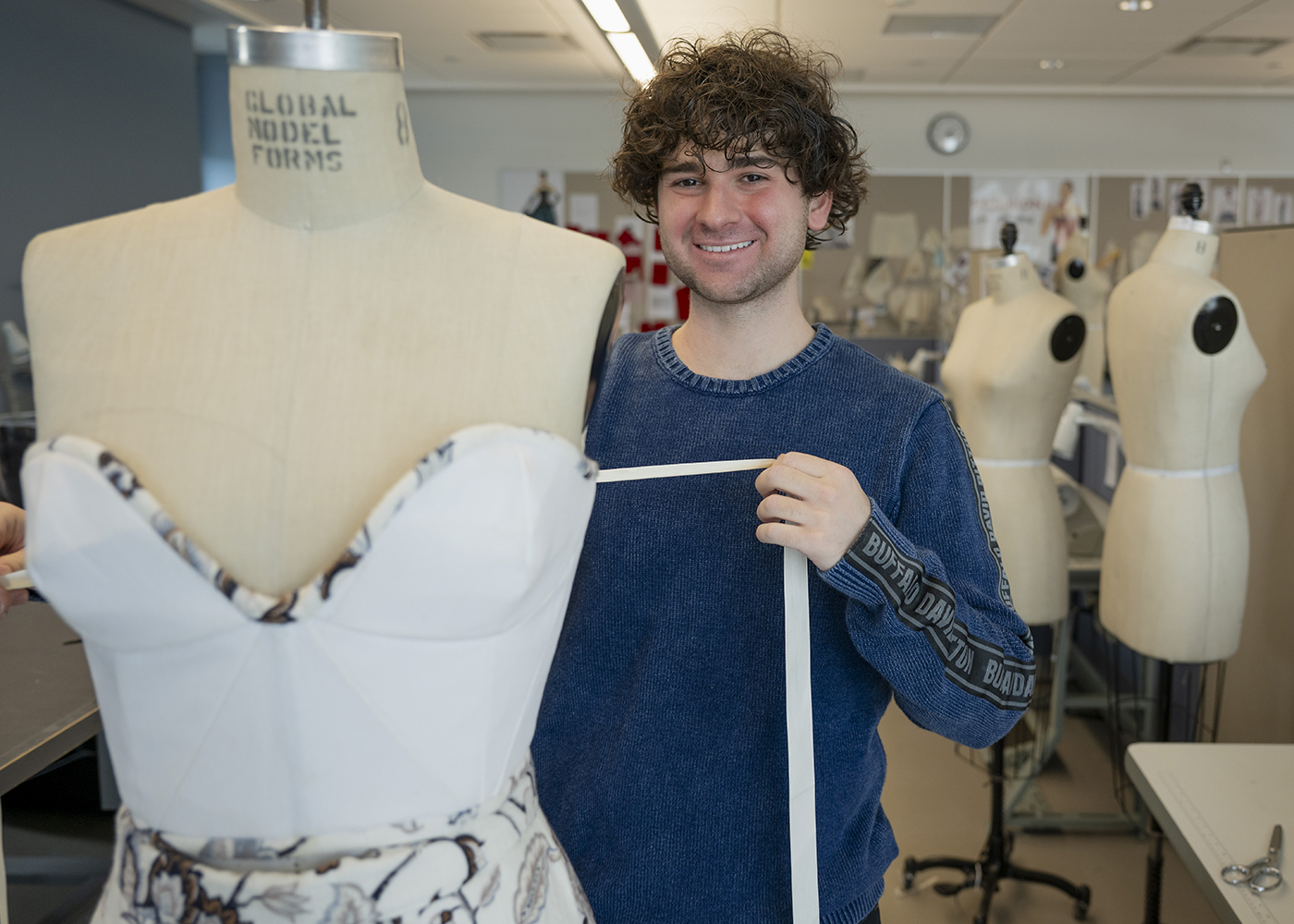 Mt. SAC fashion design student Jax Malcolm works on a class project.