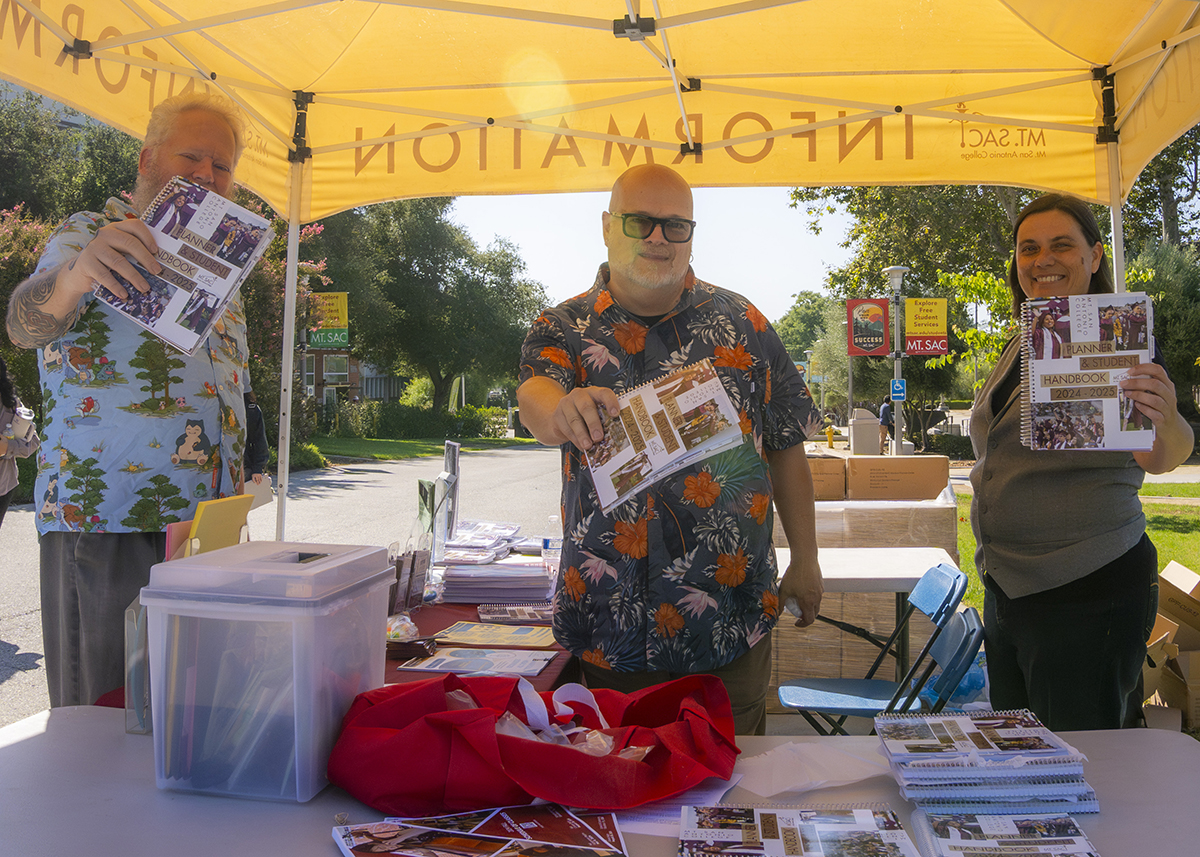 Volunteers work their shift at an information booth on campus.