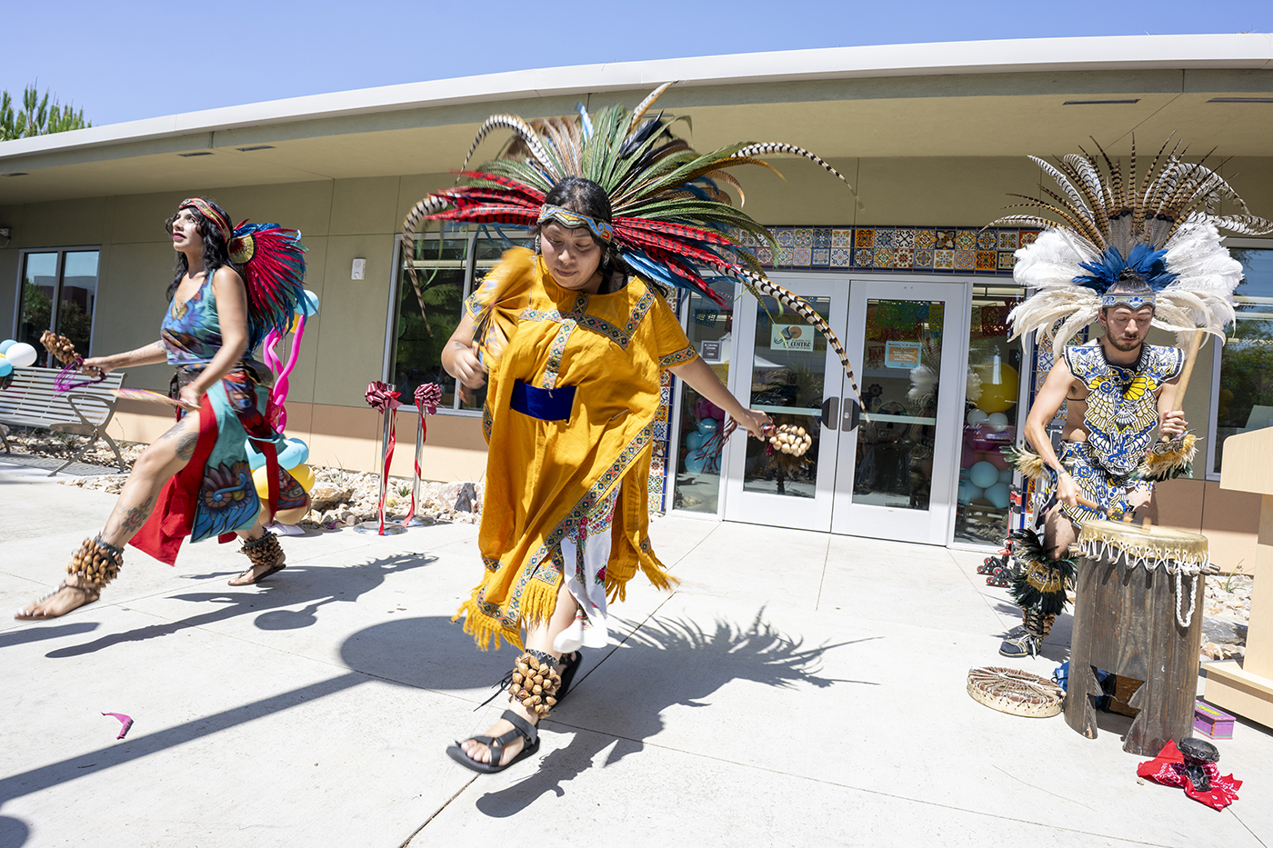 A group of Native Americans perform at a grand opening ceremony.