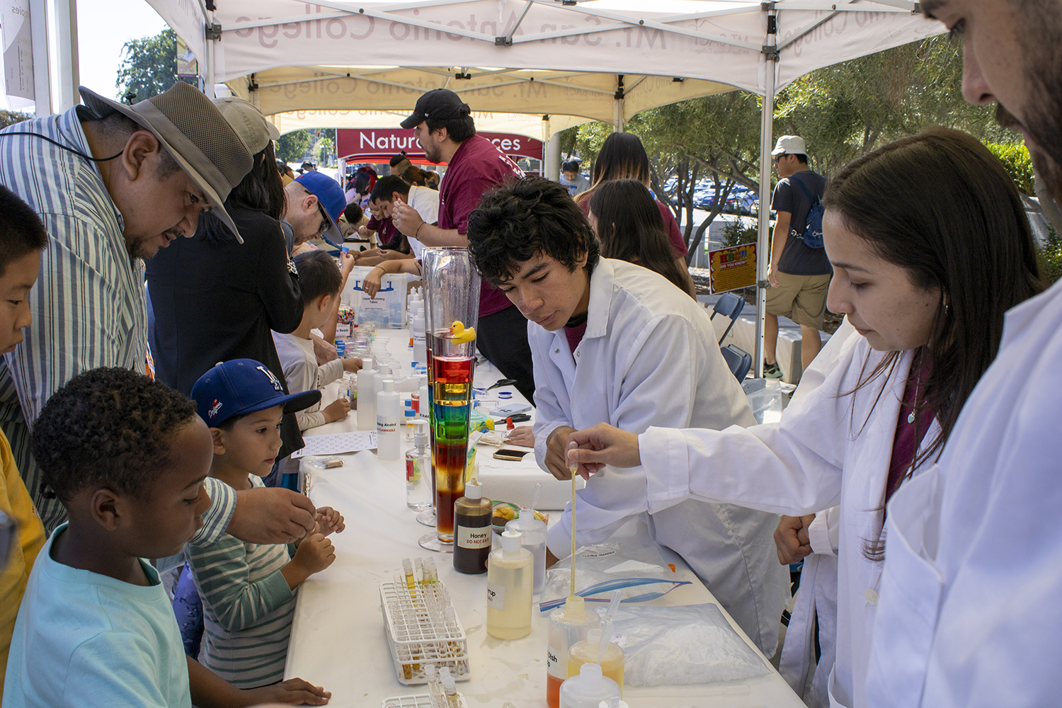 Mt. SAC science students test an experiment in front of a crowd at the Family Science Festival.