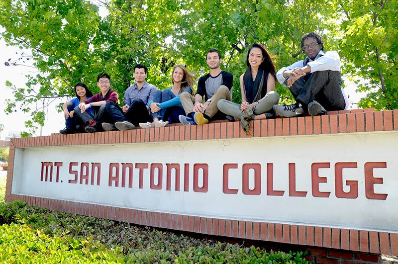 Students sitting on a wall