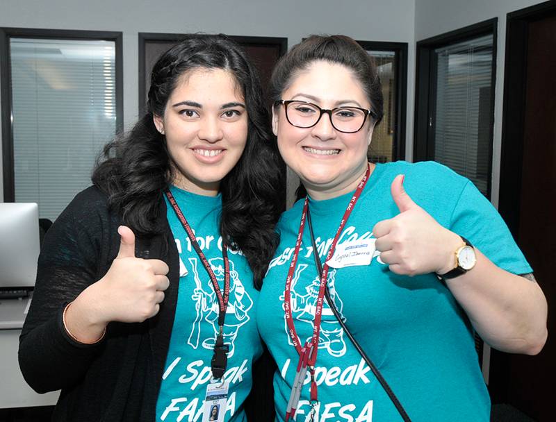 student employees with thumbs up