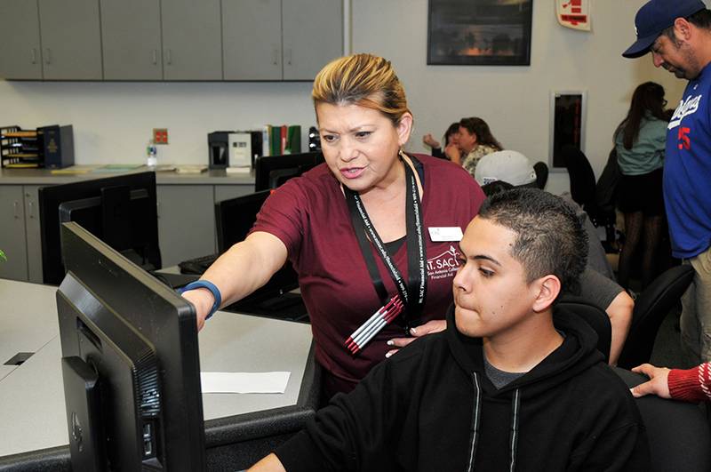 staff helping a student at Cash for College