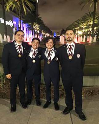 image of four HOSA students posing with medals