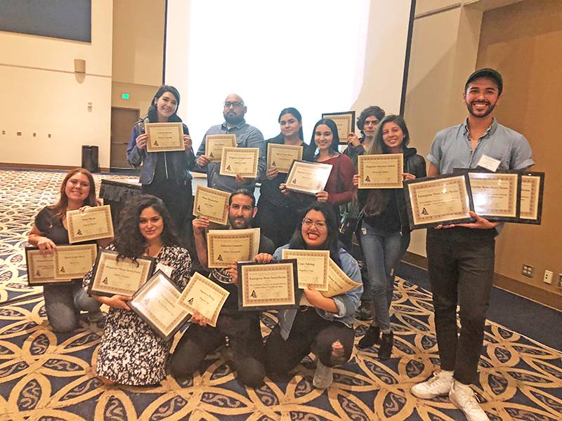 journalism students posing with awards