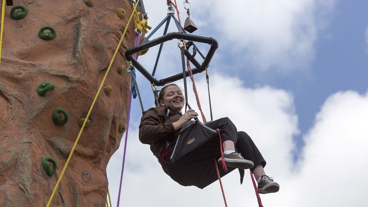 Girl on rock climbing wall